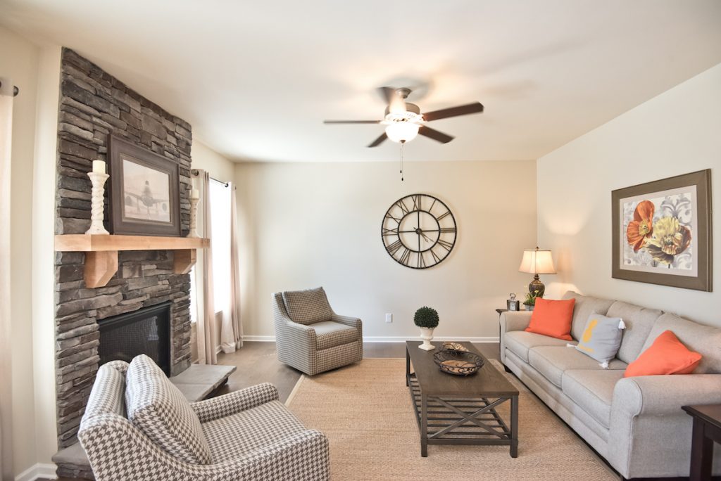 Cozy Family Room with Stone Fireplace - Decorated model home