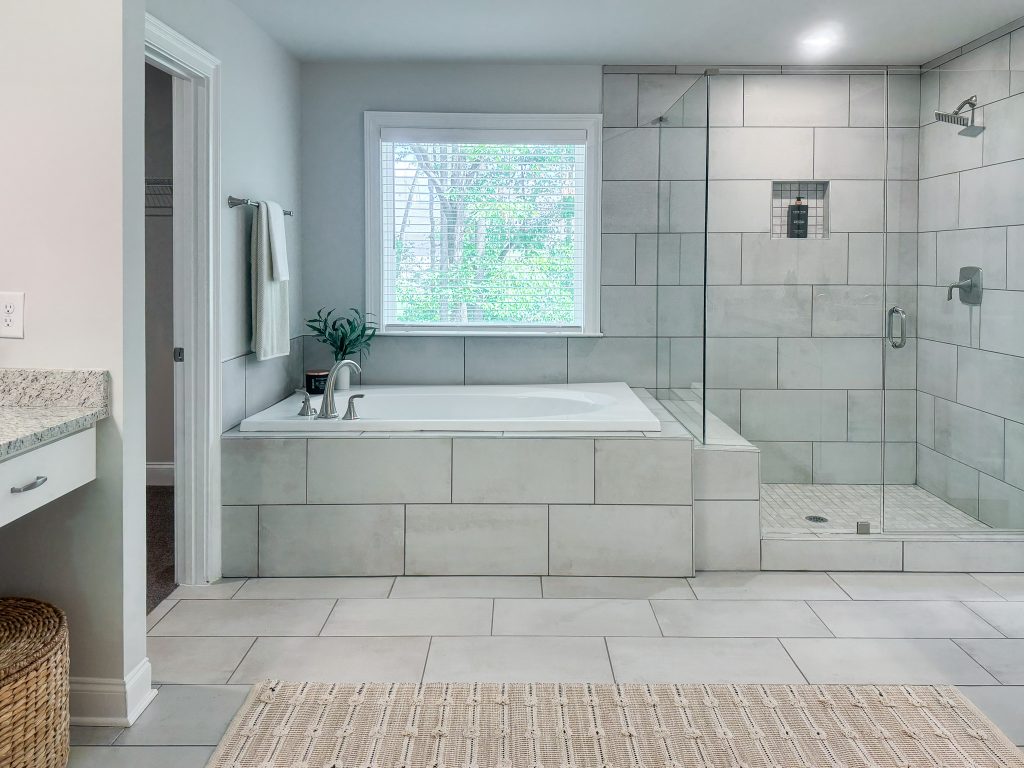 Modern tiled bathroom with tub and standing shower