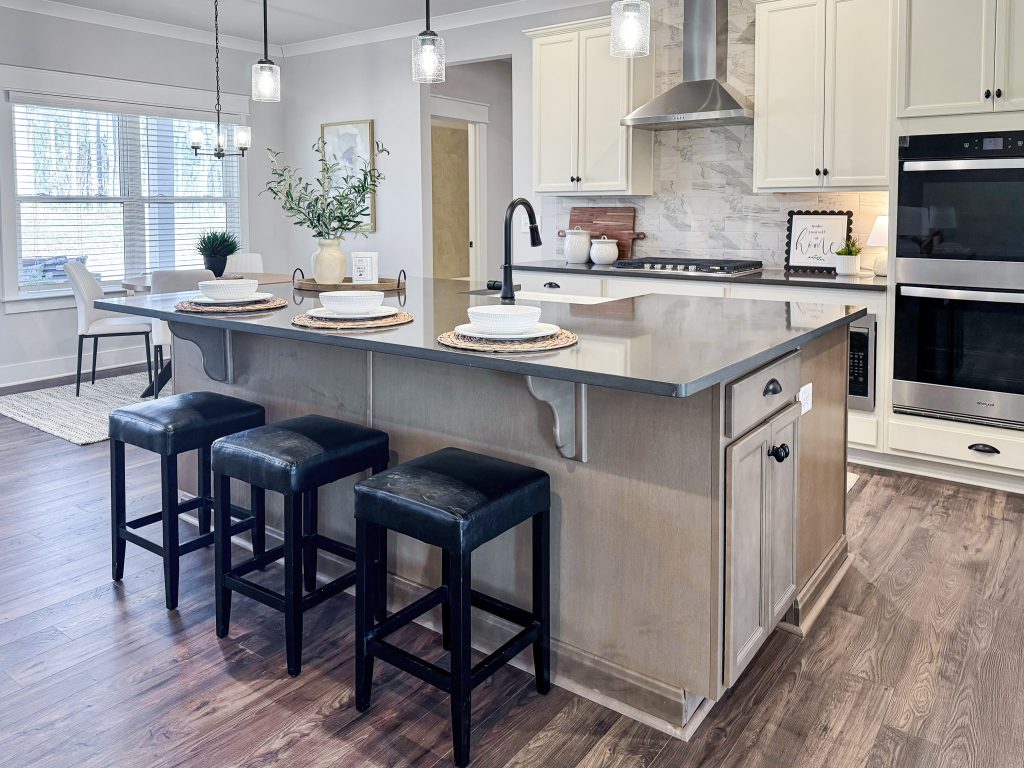 Kitchen island with brown cabinets and sink