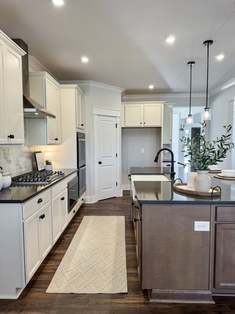 Side view of kitchen counter and island with rug in between