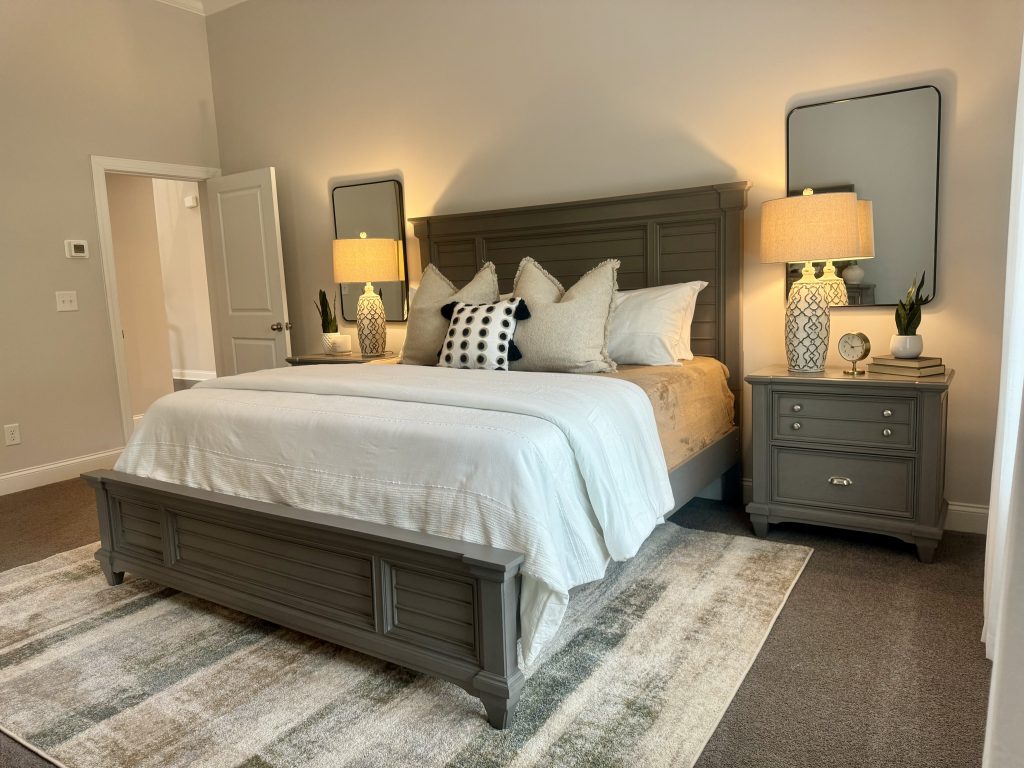Primary bedroom with bed, lamps, and side tables