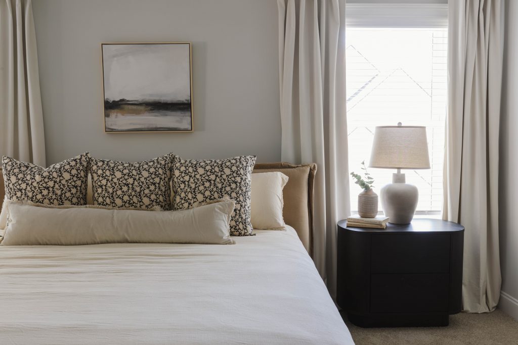 Zoomed in image of primary bed with black side tables