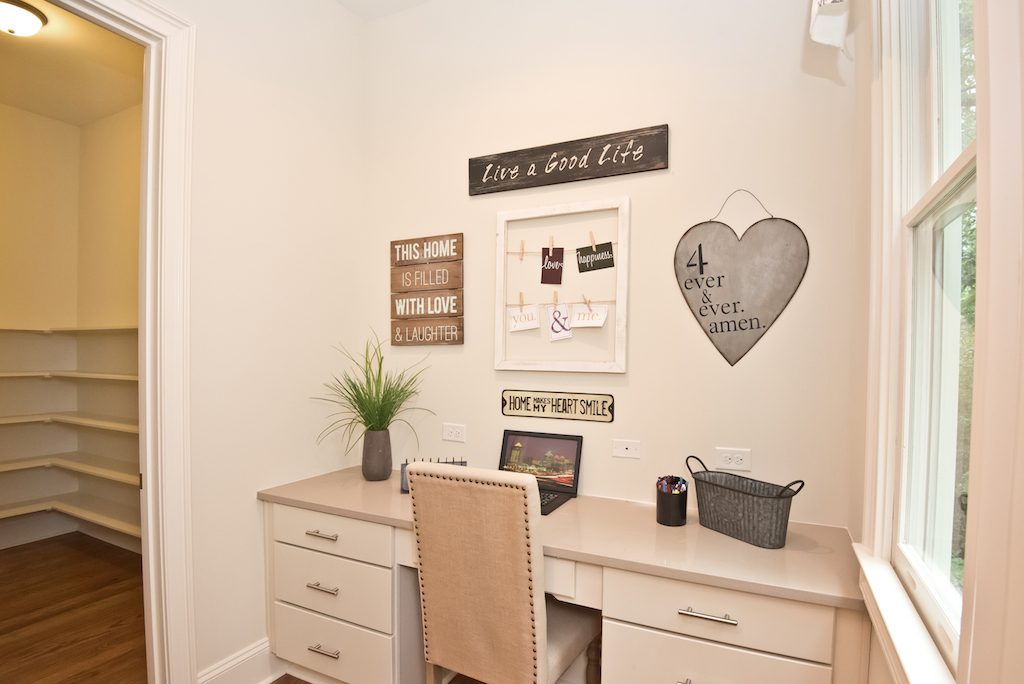 A built-in desk against a short wall near natural lighting is the perfect space for productivity.