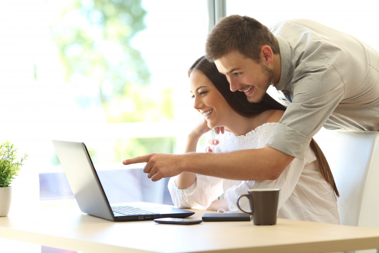 A couple looking at online promotions for new homes and rate buydowns