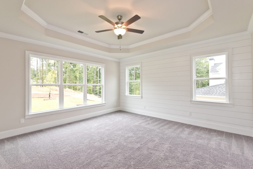 Interior of a Semi-Custom Home in Gunnerson Pointe with Tray Ceilings and a Shiplap Accent Wall