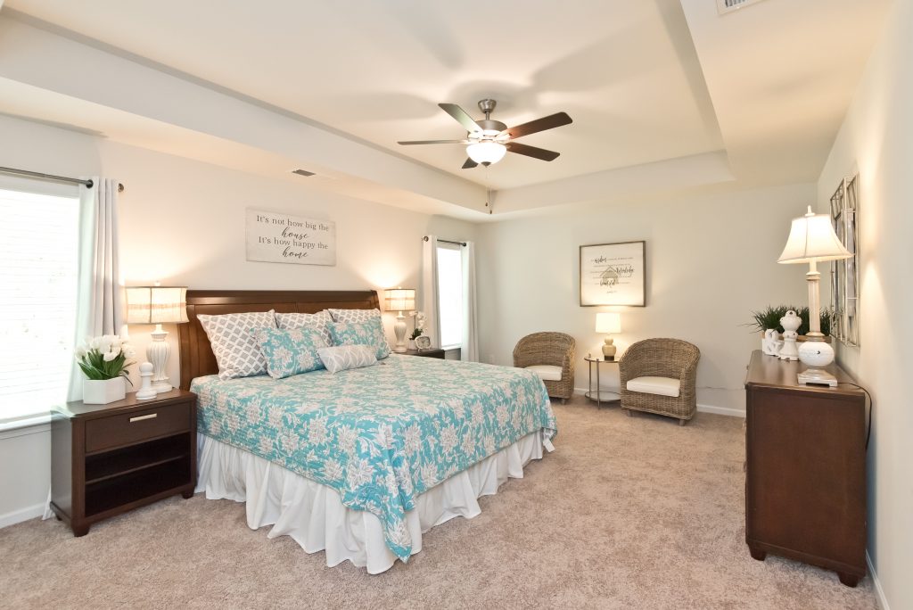 A master bedroom with tray ceilings