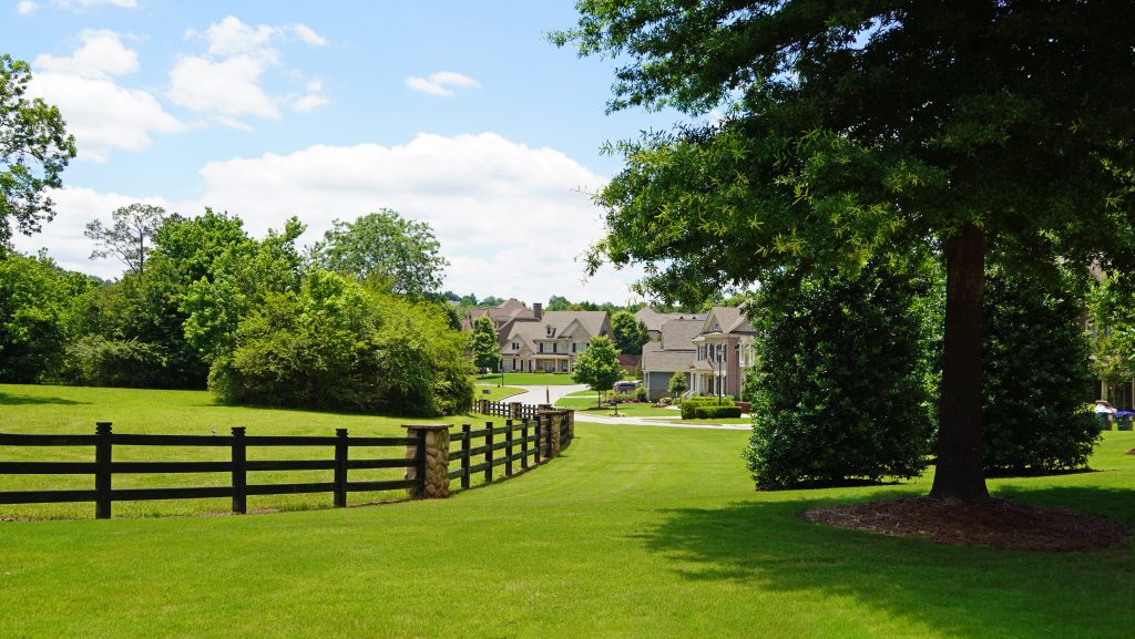 River Rock community with green grass and houses in distance