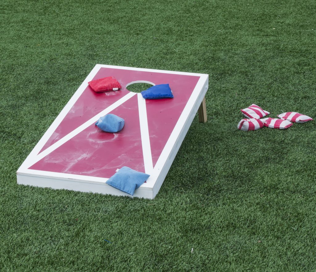 David Wood a game of cornhole, one of many lawn activities