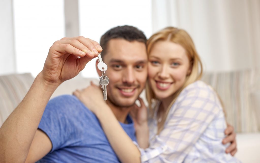 Couple holding keys to new house