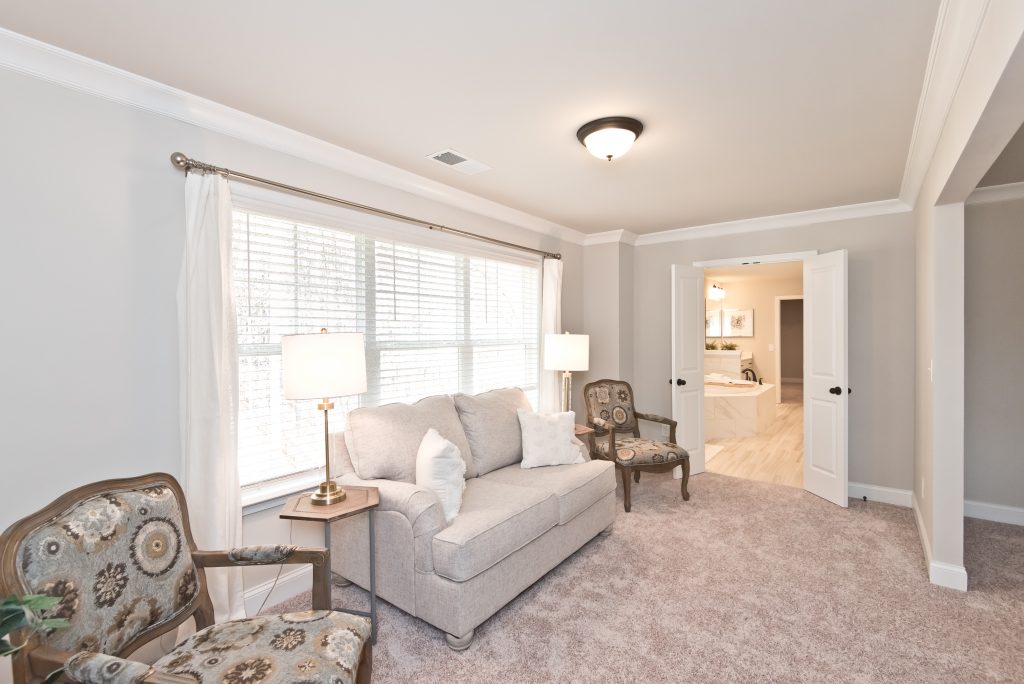 a sitting area in a master bedroom