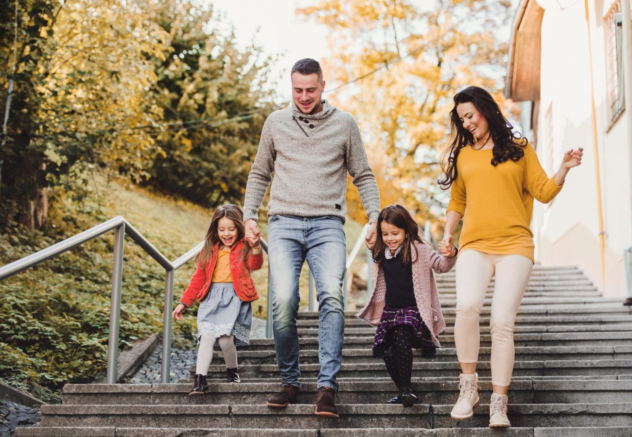 Family of four walking outside in fall ©Halfpoint