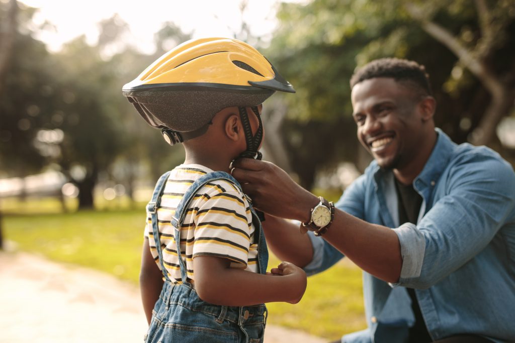 father and son with bicycle helmet family Jacob Lund © Shutterstock