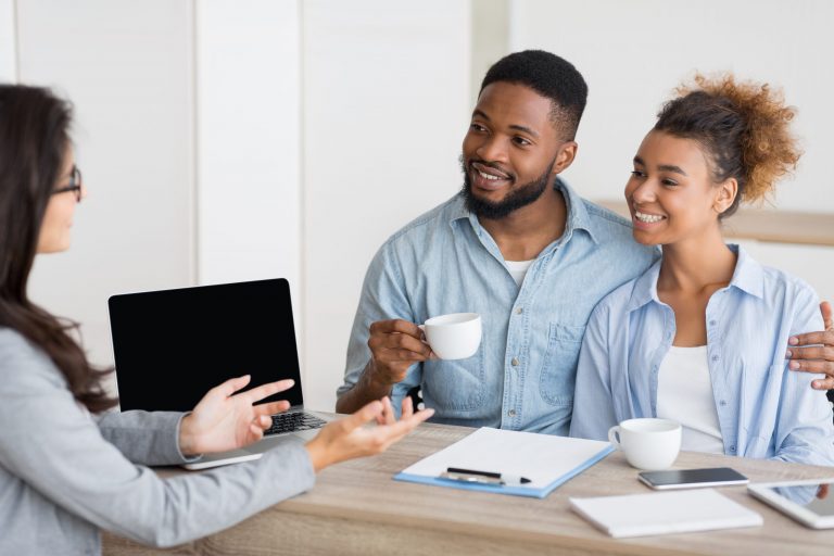 Young couple talking with an agent about buying a new home ©Prostock-studio