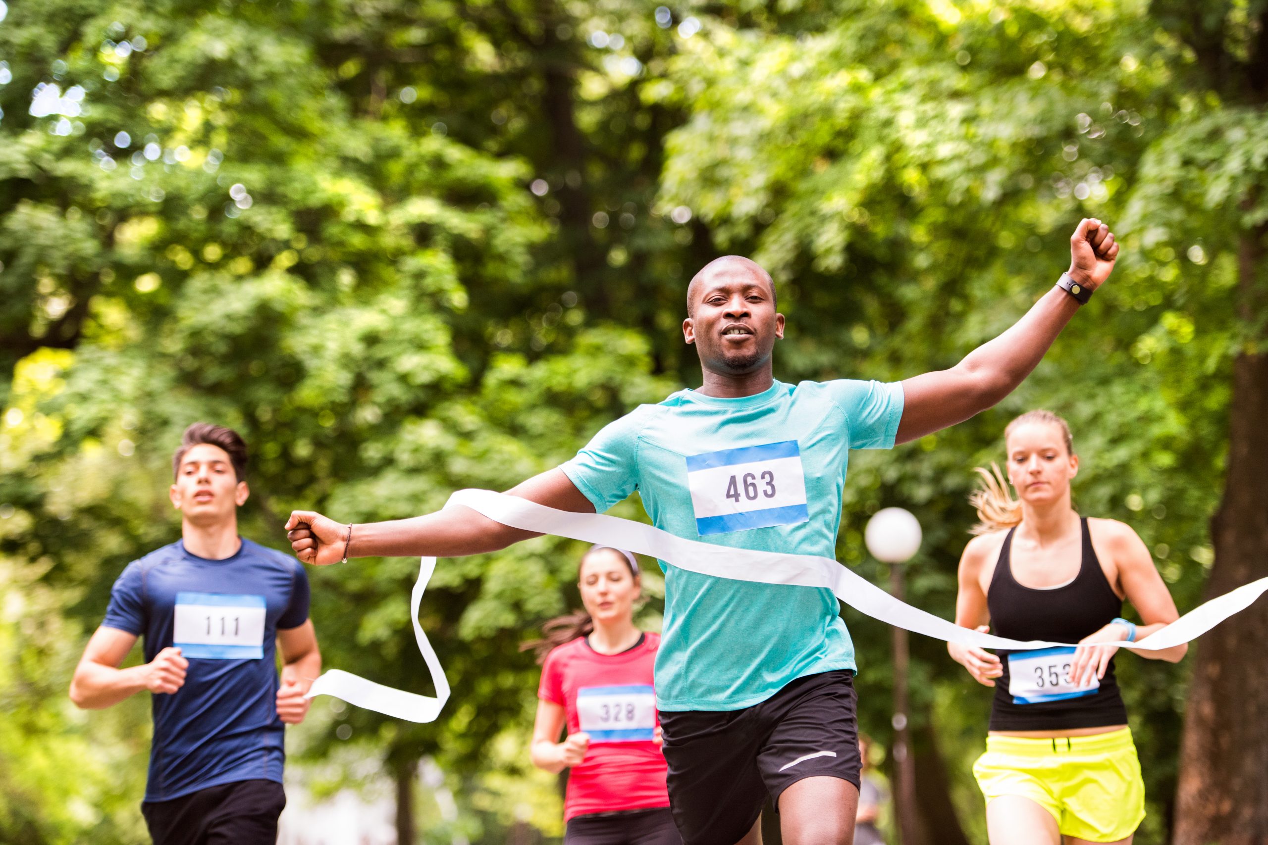 Man crossing the finish line of a race ©Ground Picture