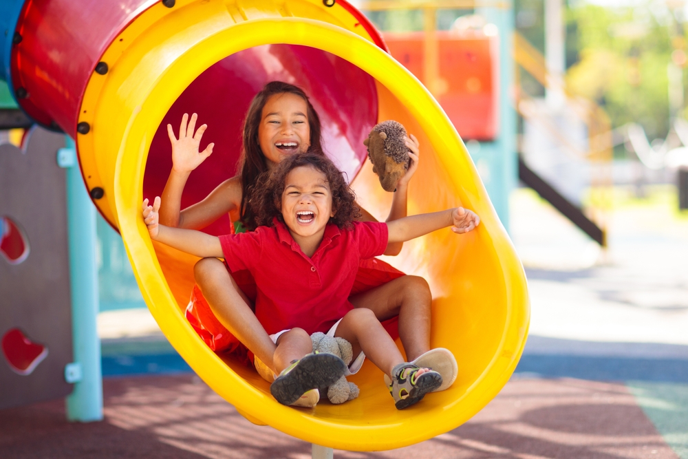 Kids on playground. Children play outdoor on school yard slide. ©VamFeld
