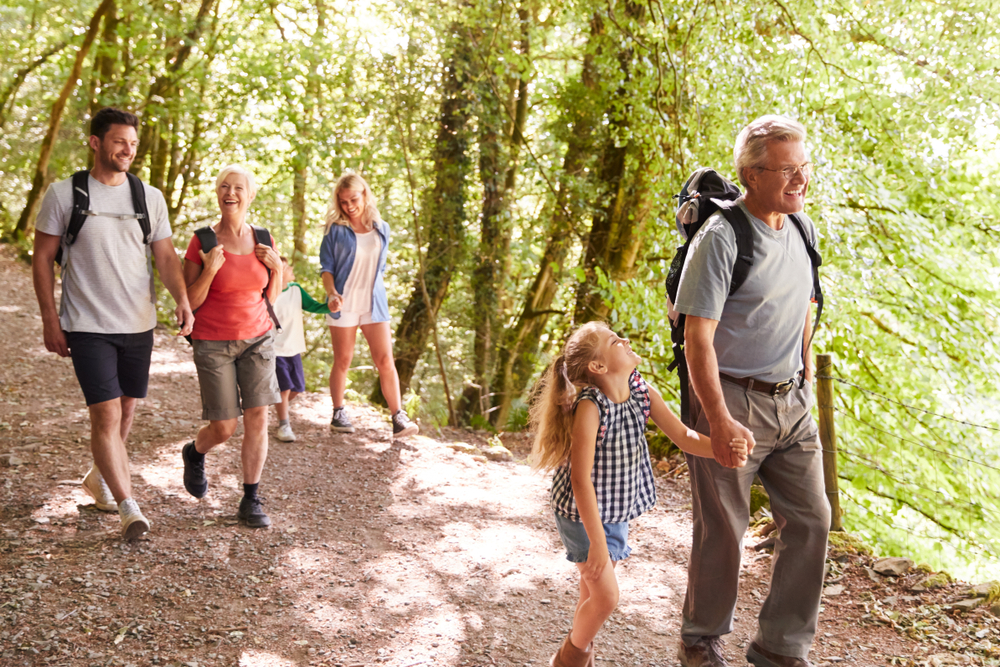 Multi Generation Family Enjoying Walk Along Woodland Path Together ©Monkey Business Images