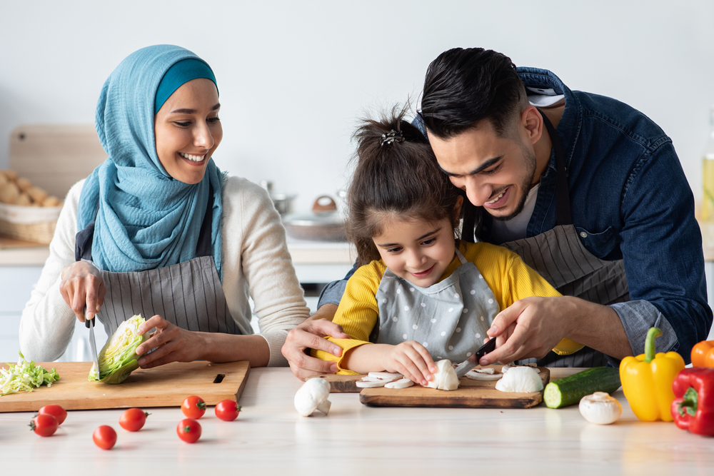 Parents Teaching Their Daughter How To Cook Healthy Food ©Prostock-studio