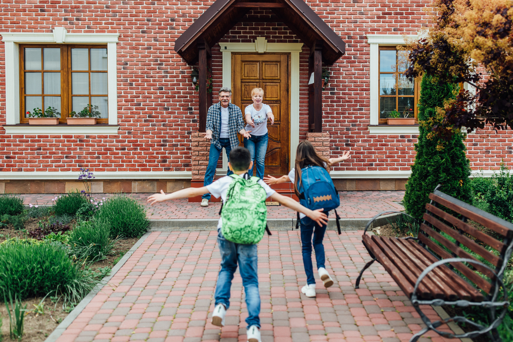 Grandparents welcoming grandkids in multigenerational home ©EZ-Stock Studio