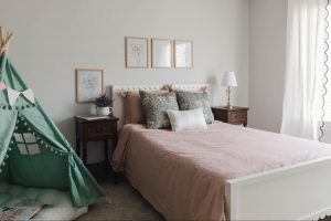 The floral artwork ties this bedroom together and brings out the color in the bedding