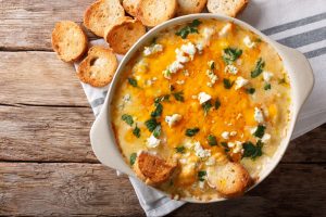Bowl of homemade chicken buffalo dip with toasted bread. ©Sergii Koval