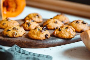 Pumpkin chocolate chip cookies on a wooden serving board. ©Edalin Photography