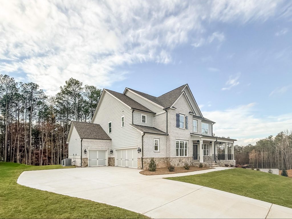 Brick-front townhome with two-car garage at Park Center Pointe in Austell, GA by Kerley Family Homes.