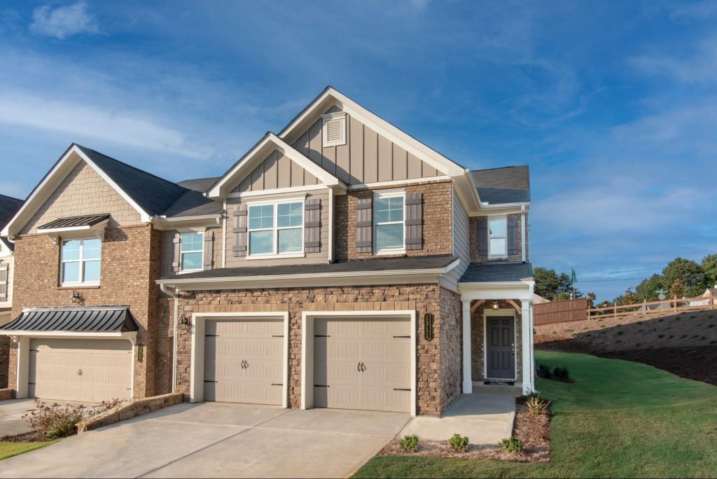 Brick-front townhome with two-car garage at Park Center Pointe in Austell, GA by Kerley Family Homes.