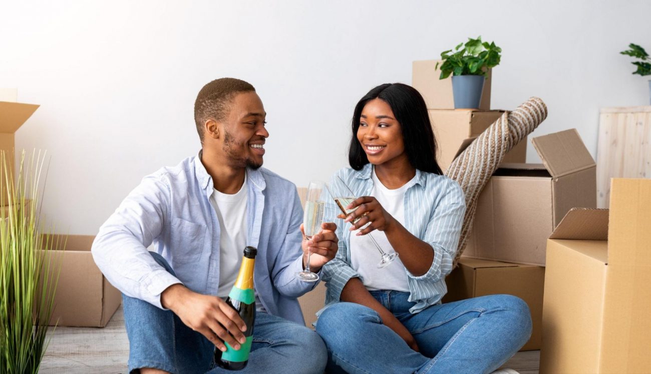 Happy couple celebrating move-in day with champagne in their new Kerley Family Home. ©Prostock-studio