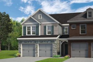 Luxury three-story townhomes with dark siding and stone accents at Morris Mills in Mableton, GA. 