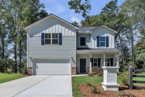 Two-story blue craftsman-style single-family home with white trim at Sweetlake Grove in Mableton, GA. 